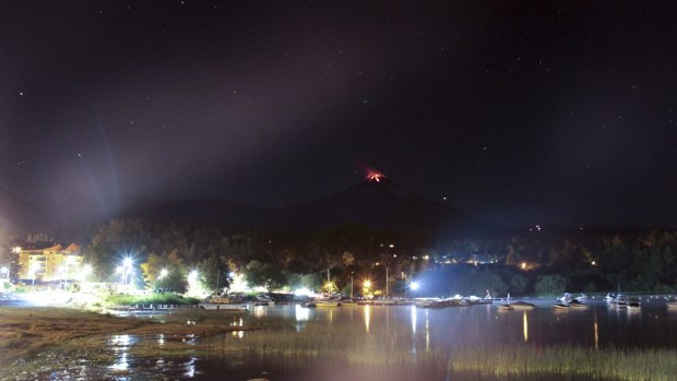 The Villarica volcano erupts in the background near Pucon, Chile. 