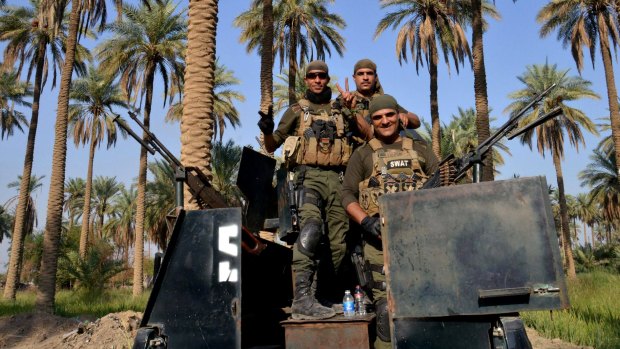 In force: Iraqi security forces patrol Jurf al-Sakhar, south of Baghdad, in October.