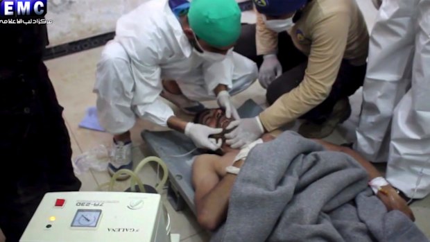 A victim of a suspected chemical attack receives treatment at a makeshift hospital.