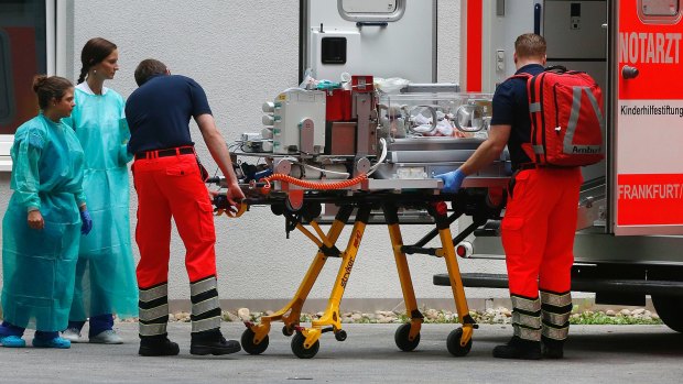 A premature infant is taken to an ambulance to be transported from the Bürgerhospital to another hospital in Frankfurt. Bürgerhospital is within the evacuation zone.