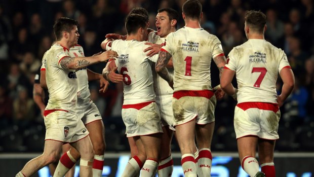 England celebrate after a Brett Ferres try.