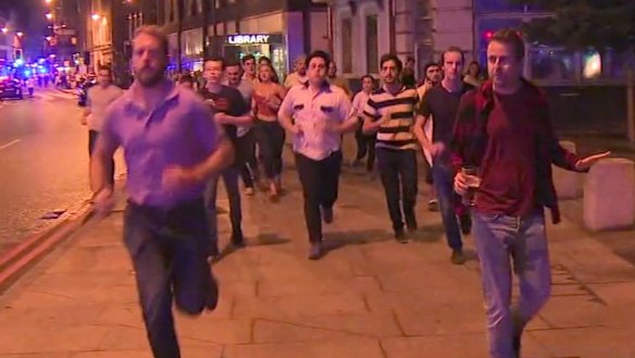 A man holds his beer while people flee terror attacks in London on Saturday. 