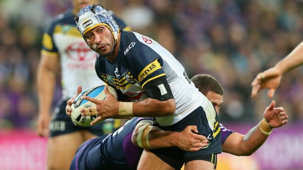 Leading the way: Johnathan Thurston is tackled during the Cowboys' preliminary final win over the Storm at AAMI Park.
