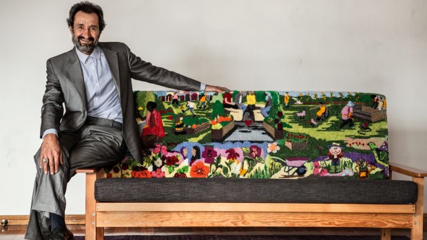Sayd Shahmamood Abdali and the tapestry couch he helped craft.
