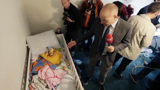 Members of the media crowd into a child's room in an apartment in Redlands, California, shared by San Bernardino terrorists Syed Farook and his wife, Tashfeen Malik.