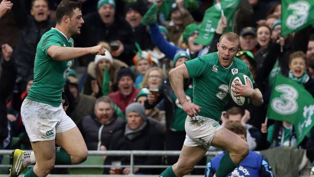Ireland's Keith Earls, right, runs,  on his way to scoring his side's second try, during the Six Nations rugby union international match between Ireland and Scotland, in Dublin, Ireland,  Saturday March 19, 2016. (Brian Lawless/PA via AP) UNITED KINGDOM OUT NO SALES NO ARCHIVE