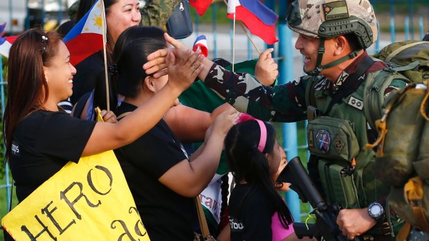 One of the first battalions to be deployed in the besieged city of Marawi in southern Philippines, arrives to a hero's welcome at Villamor Air Base in Pasay city southeast of Manila.