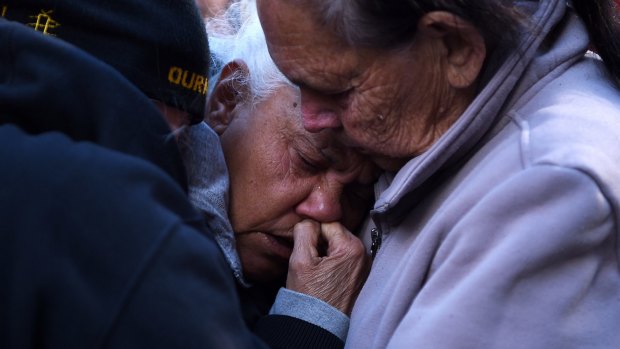 Diane Whittaker (centre) is comforted by Daisy Fernando (right) both Aunties of Eric Whittaker who died in custody. 