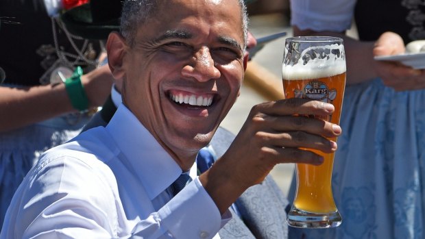 US President Barack Obama holds a glass of beer at a breakfast meeting with the German chancellor and local citizens in Kruen, in southern Germany.