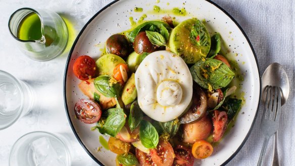 Burrata cheese balls with heirloom tomatoes and basil oil.