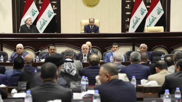 Iraqi Prime Minister Haider al-Abadi, centre, attends Parliament in Baghdad.