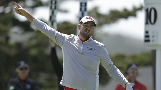 Leishman gestures right after hitting from the tenth tee.