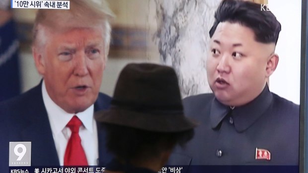 A man watches a TV showing US President Donald Trump and North Korean leader Kim Jong-un, in South Korea.