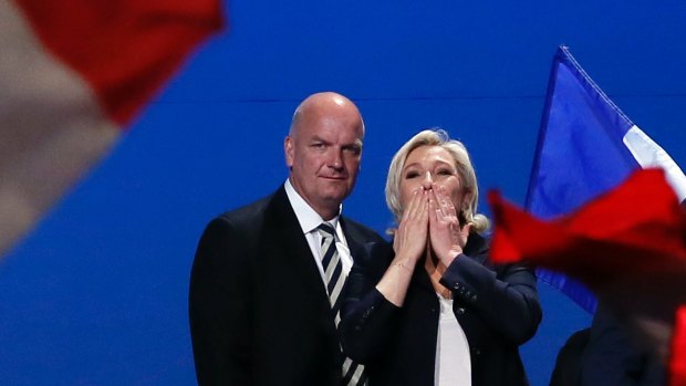 French far-right presidential candidate Marine Le Pen, flanked by her bodyguard Thierry Legier, blows kisses to supporters at the end of her meeting in Villepinte, outside Paris.