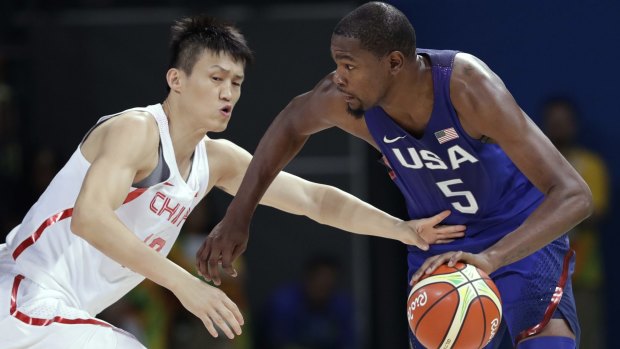 United States' Kevin Durant (5) drives past China's Zou Peng, left, during at preliminaries of the Men's basketball at Carioca Arena 1, in Rio.