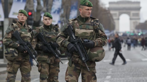 French soldiers of the foreign legion patrol along at the Champs Elysees avenue during the New Year parade in Paris.
