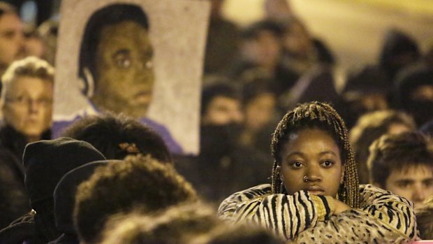 Paying respects: Demonstrators mark a moment of silence following the grand jury decision at a protest in Seattle, Washington.