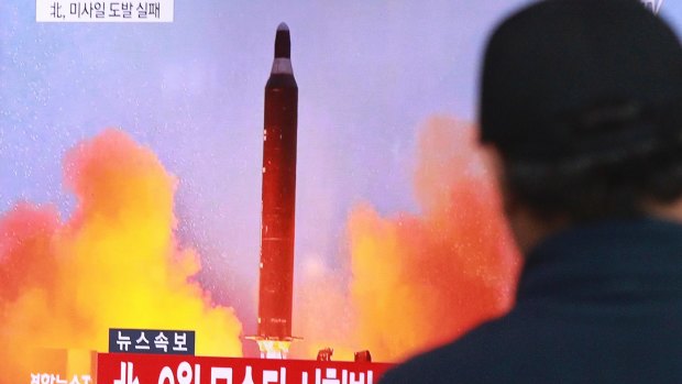 A man watches a TV news program on North Korea's missile launches at Seoul Railway Station, South Korea.