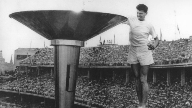 Ron Clarke lights the flame at the 1956 Melbourne Olympics.