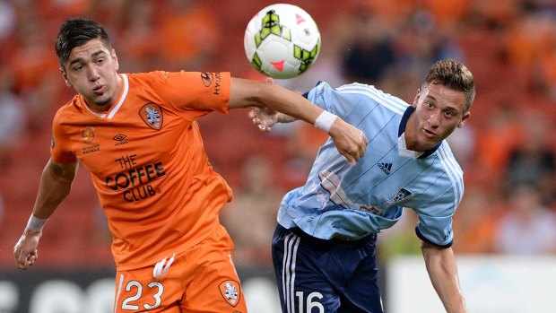 Eyes on the prize: Brisbane’s Dimitri Petratos and Sydney FC’s Chris Naumoff do battle for possession. 