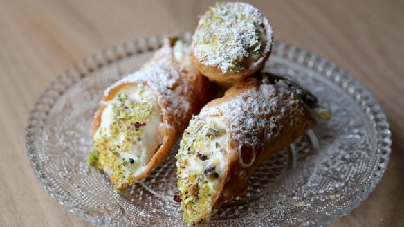 Cannoli stuffed with ricotta and dipped in pistachio is a Sicilian dessert staple.