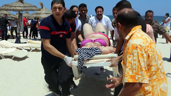 Tunisian medics carry a woman on a stretcher in the resort town of Sousse.