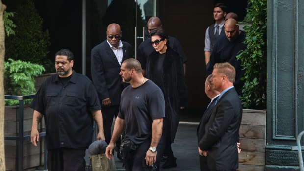 Kardashian West's mother Kris Jenner surrounded by security as she leaves the New York residence where her daughter is staying on Monday.