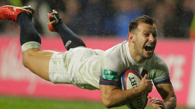 England's Danny Care smiles as he goes over the line for England's fourth try.