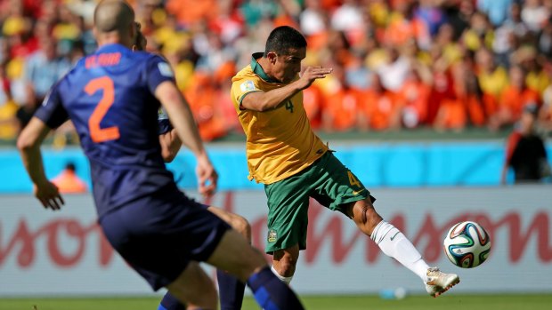 On target: Tim Cahill launches his wonder strike against the Dutch at the World Cup.