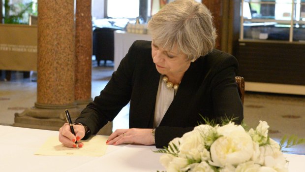 Prime Minister Theresa May signs a condolence book in Manchester. The Tories have taken a dip in the polls since last week's bombing. 