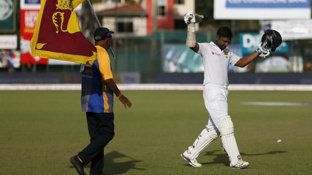 All class: Sri Lanka's Kumar Sangakkara waves his bat  as he walks off for the last time. 