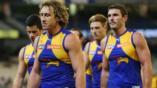 Humbled: Matt Priddis and the Eagles walk off the MCG after losing to Collingwood.
