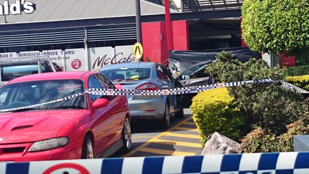A blue Ford Mondeo parked outside the Helensvale McDonald's may be linked to the fatal shooting of a woman.