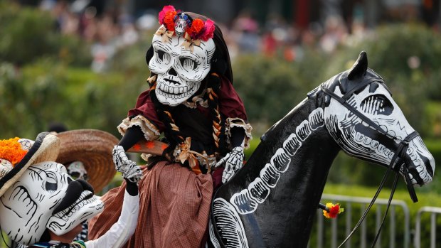 Mexico's capital is holding its Day of the Dead parade, an idea actually born out of the imagination of a scriptwriter for the James Bond movie, Spectre.