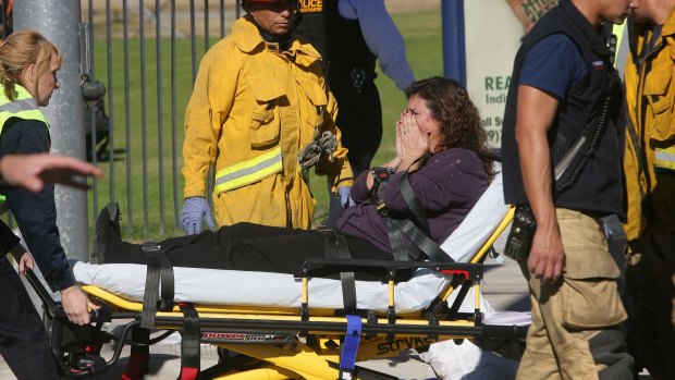 A victim is wheeled away on a stretcher following the shooting.