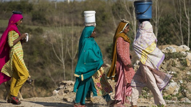 Pakistani women fetch clean water for their families.