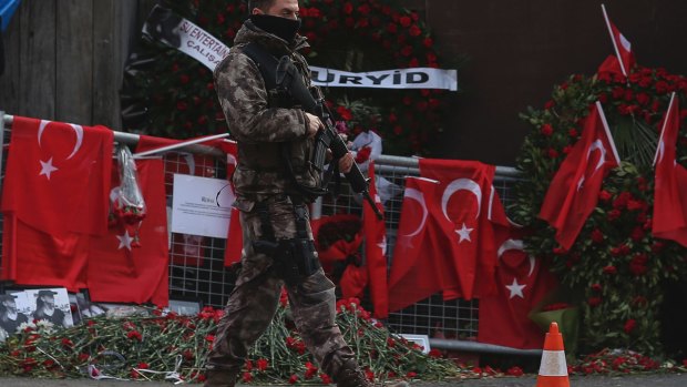 A Turkish special security force member patrols near the scene of the nightclub attack.