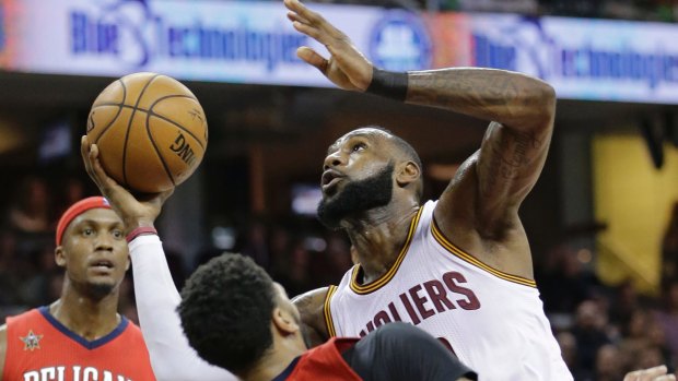 Cleveland Cavaliers' LeBron James, right, is called for an offensive foul against New Orleans Pelicans' Anthony Davis in an NBA clash in Cleveland. 