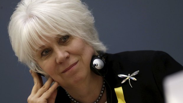 Estonia's Minister of Foreign Affairs Marina Kaljurand wears a yellow ribbon in support of Estonian police officer Eston Kohve.