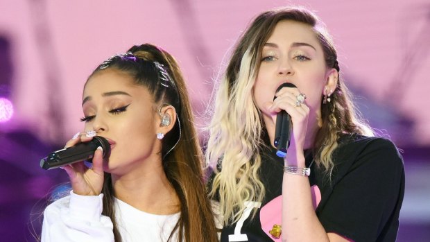 Ariana Grande, left, and Miley Cyrus perform at the One Love Manchester tribute concert in Manchester on Sunday, June 4.
