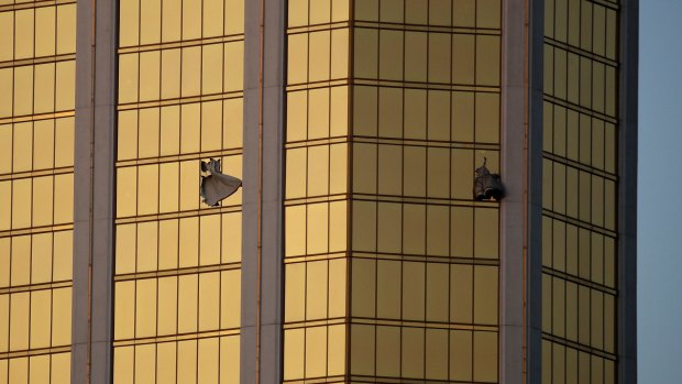 Drapes billow out of broken windows at the Mandalay Bay resort and casino following the deadly shooting.