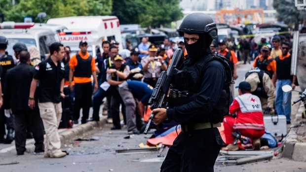An Indonesian policeman stands guard in front of a blast site in the aftermath of the January 14 Jakarta attacks.