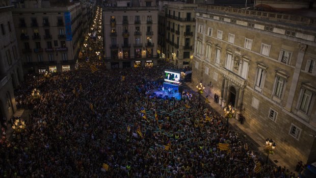 Pro-independence supporters gather at Sant Jaume square to celebrate following the parliamentary vote to declare Catalan independence in Barcelona.