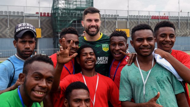Making friends: James Tedesco at a coaching clinic in Port Moresby.