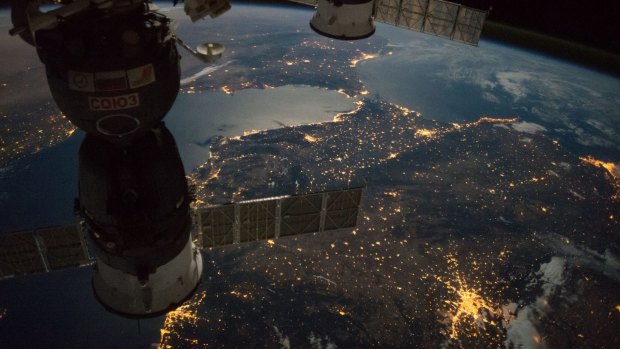 The International Space Station camera captures a nighttime view of the Strait of Gibraltar with a Russian Soyuz spacecraft (left) and Progress spacecraft in the foreground. You can see the lights of Madrid and Valencia bottom of frame with Rabat and Casablanca towards the top.