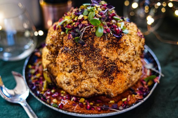 Christmas centrepiece: Whole-roasted spice-rubbed cauliflower sitting on romesco.