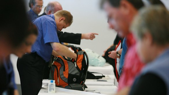Security at Los Angeles airport conducts a search on carry on baggage.