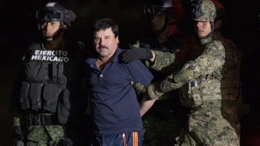 Mexican drug lord Joaquin 'El Chapo' Guzman is escorted by soldiers after being recaptured.