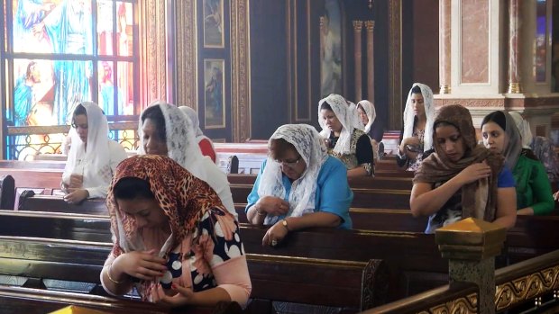 Russian tourists and Egyptian Coptic Christians pray at the Coptic Orthodox Cathedral of the Heavens in Sharm El-Sheikh on Sunday. 