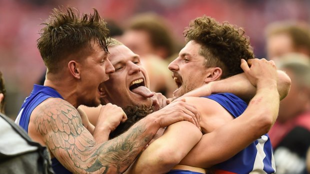 Lapping it up: Bulldogs Clay Smith, Jake Stringer, Luke Dahlhause and Tom Liberatore celebrate their win for the ages.